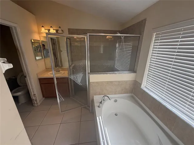 a bathroom with a bathtub and a shower