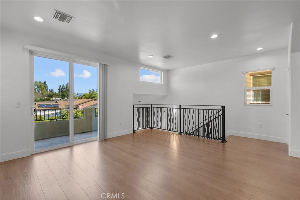 16863 Balboa Boulevard Van Nuys, CA 91406 - Photo 12 of 34 a view of a hallway with wooden floor and windows