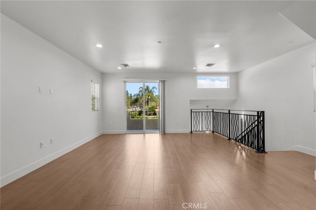 16863 Balboa Boulevard Van Nuys, CA 91406 - Photo 13 of 34 a view of an empty room with wooden floor and a window