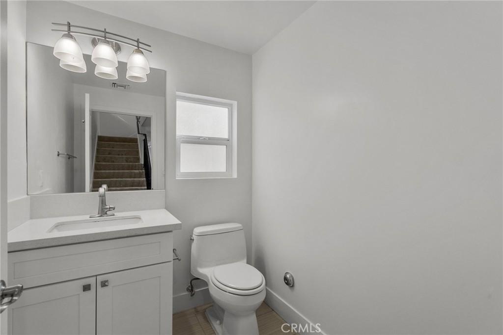 16863 Balboa Boulevard Van Nuys, CA 91406 - Photo 17 of 34 a bathroom with a toilet a sink and mirror