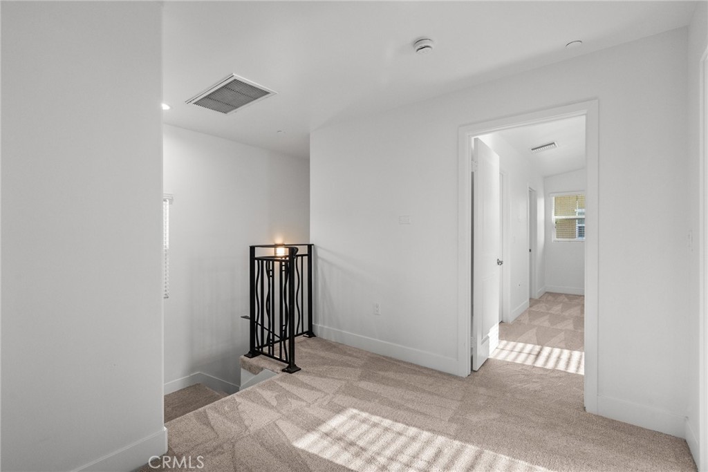 16863 Balboa Boulevard Van Nuys, CA 91406 - Photo 19 of 34 a view of a hallway with wooden floor and a bathroom