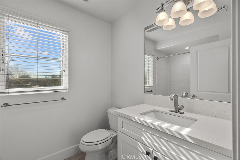 16863 Balboa Boulevard Van Nuys, CA 91406 - Photo 25 of 34 a bathroom with a sink a toilet and a mirror