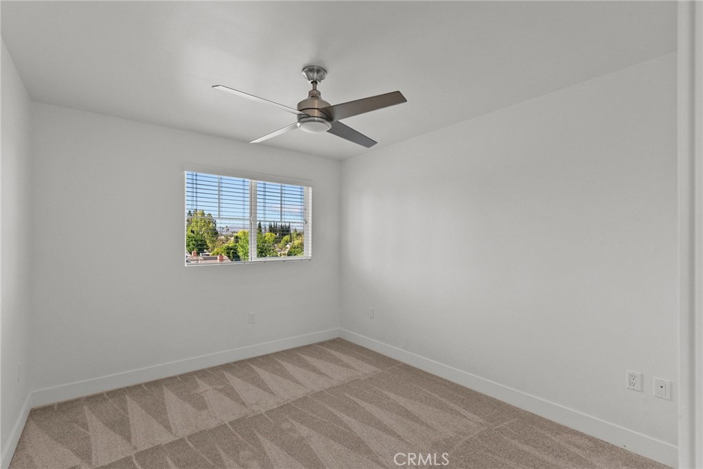 16863 Balboa Boulevard Van Nuys, CA 91406 - Photo 26 of 34 an empty room with a window and a ceiling fan