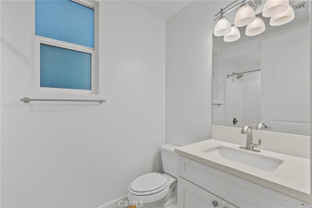 16863 Balboa Boulevard Van Nuys, CA 91406 - Photo 30 of 34 a bathroom with a toilet a sink and mirror