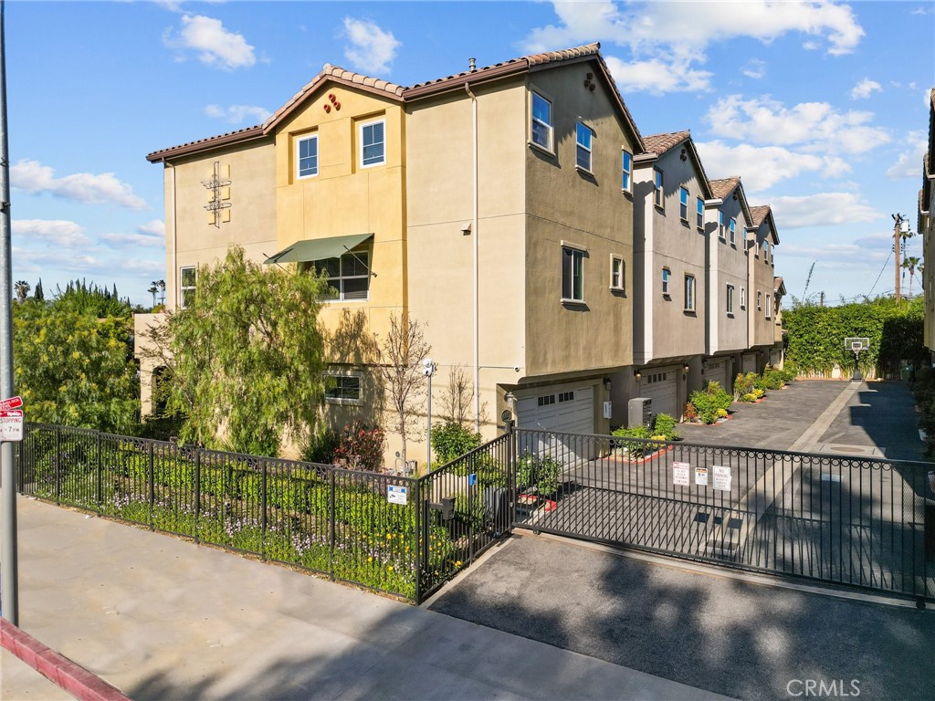 16863 Balboa Boulevard Van Nuys, CA 91406 - Photo 3 of 34 a view of a house with a small yard and plants