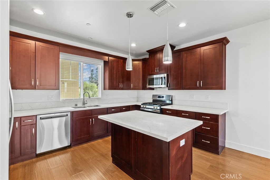 16863 Balboa Boulevard Van Nuys, CA 91406 - Photo 6 of 34 a kitchen with a stove sink and cabinets