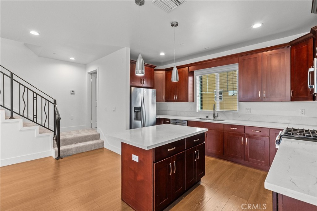 16863 Balboa Boulevard Van Nuys, CA 91406 - Photo 7 of 34 a kitchen with stainless steel appliances granite countertop a sink stove and refrigerator