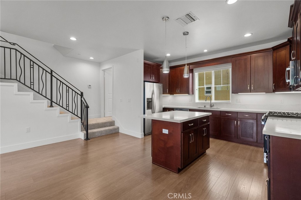 16863 Balboa Boulevard Van Nuys, CA 91406 - Photo 10 of 34 a kitchen with stainless steel appliances granite countertop a stove a sink and a refrigerator