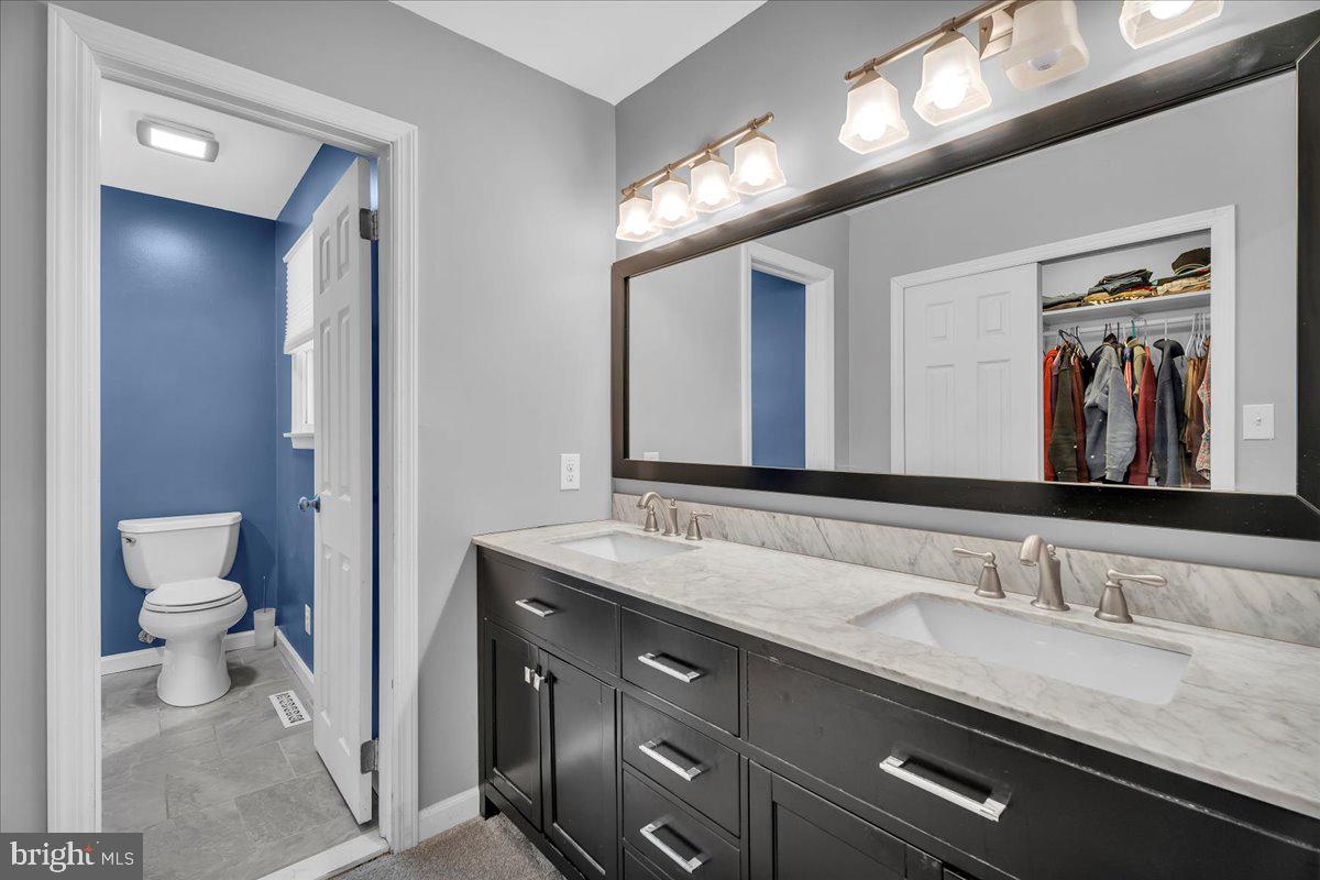 114 Peach Road Marlton, NJ 08053 - Photo 15 of 46 a bathroom with a granite countertop sink a large mirror and a toilet