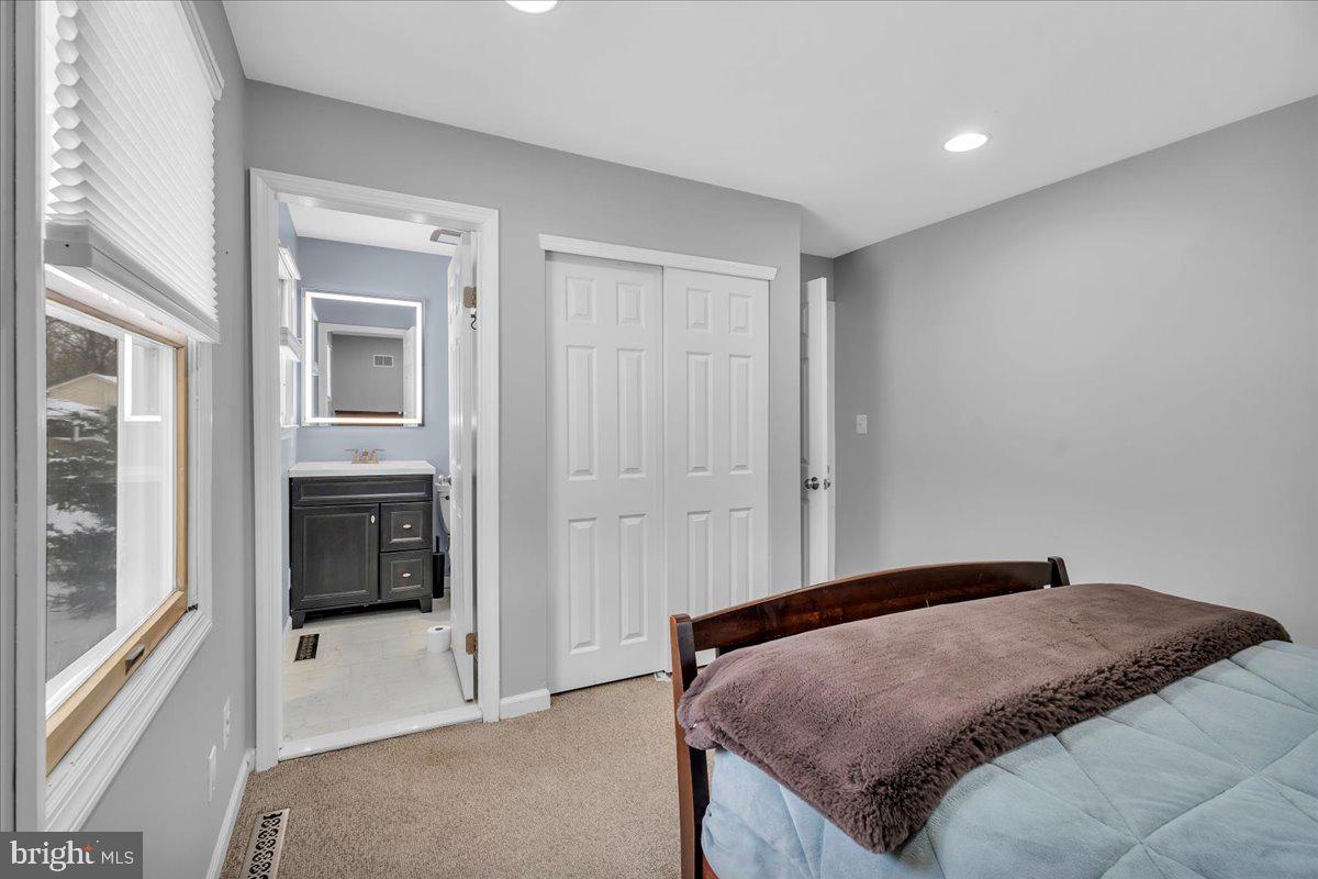114 Peach Road Marlton, NJ 08053 - Photo 19 of 46 a bedroom with a bed and a view of en suite bathroom
