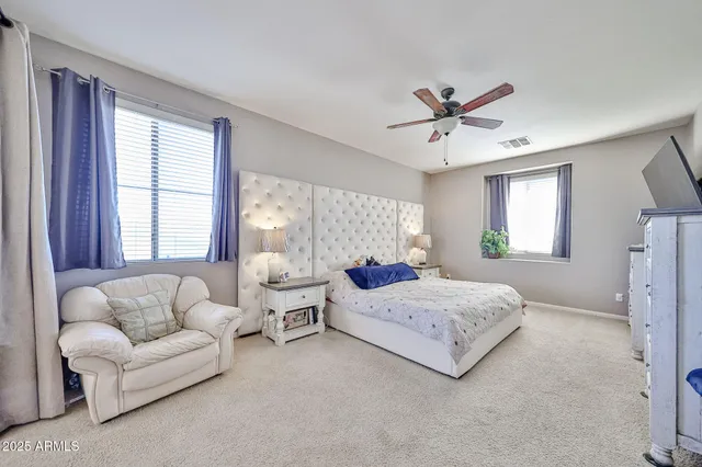 a bedroom with a bed and a dresser in it