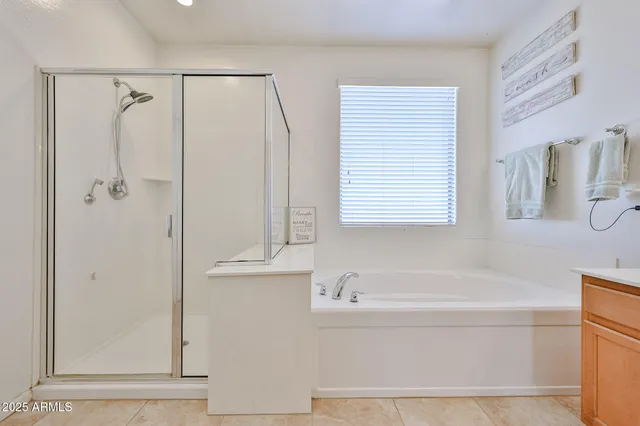 a spacious bedroom with a bed couch and windows