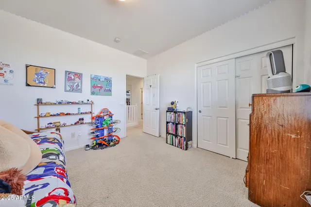 a living room with furniture a flat screen tv and a window