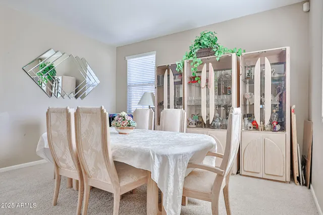 a dining room with a table and chairs