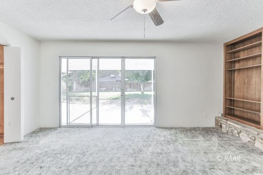 231 South Locust Street Ridgecrest, CA 93555 - Photo 9 of 35 a view of empty room with wooden floor and fan