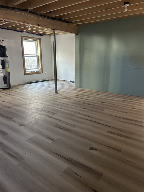209 Main Street, Unit 4 Dennis, MA 02670 - Photo 25 of 26 a view of a room with wooden floor and windows