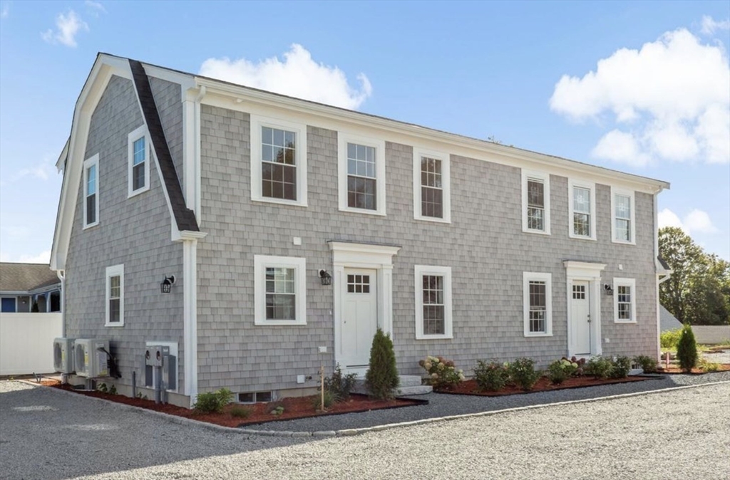 209 Main Street, Unit 4 Dennis, MA 02670 - Photo 4 of 26 a front view of a house with a yard