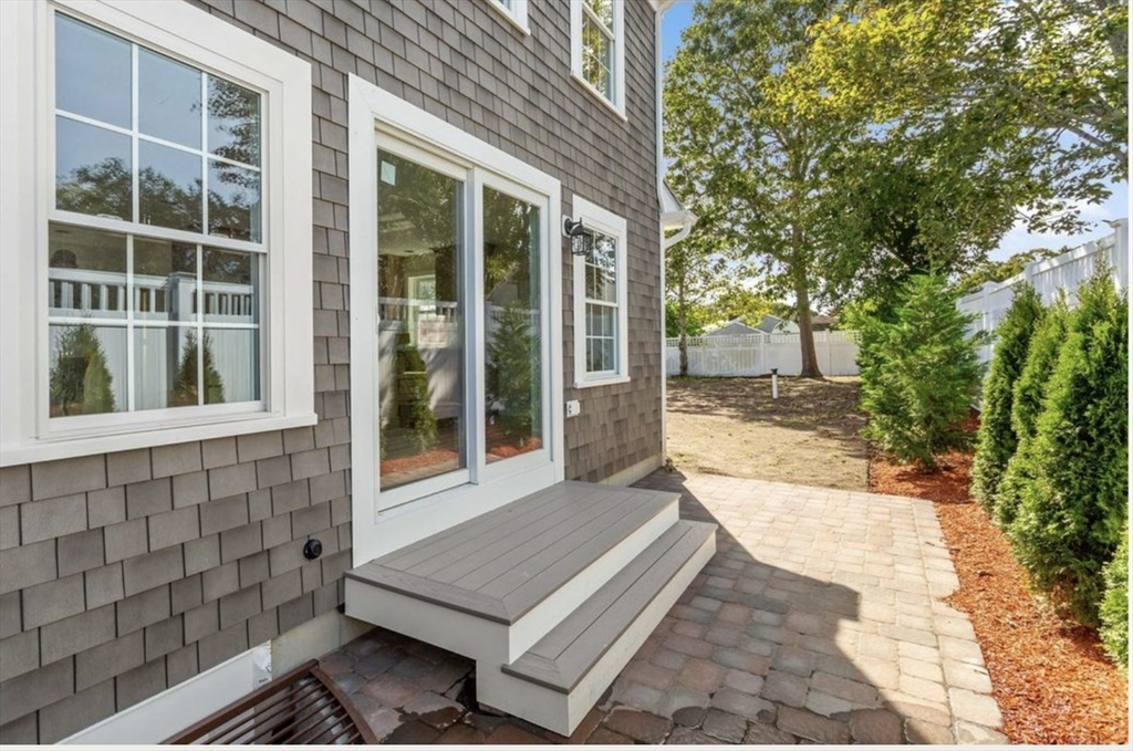 209 Main Street, Unit 4 Dennis, MA 02670 - Photo 7 of 26 a view of house with backyard and glass windows