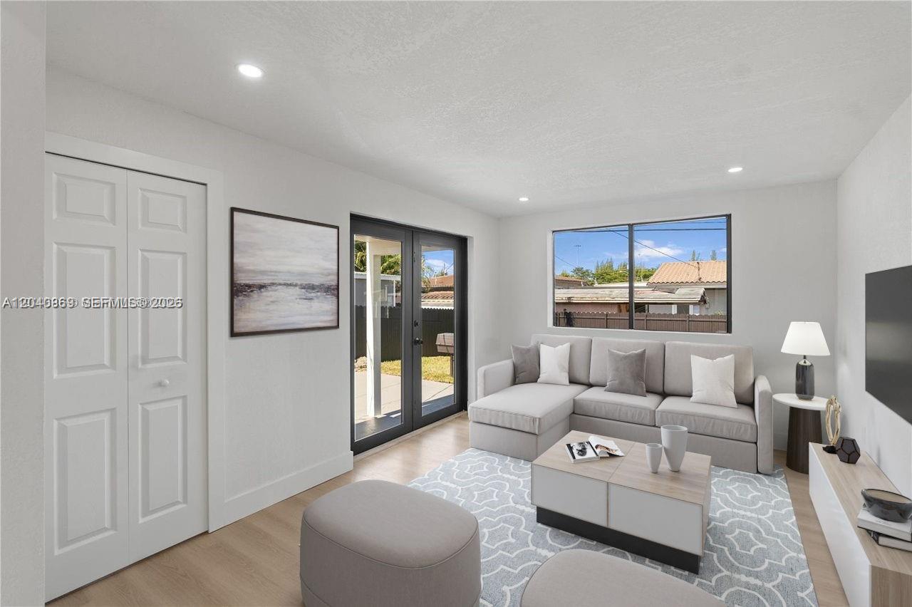 31 West 64th Street Hialeah, FL 33012 - Photo 25 of 49 a living room with furniture and a glass door