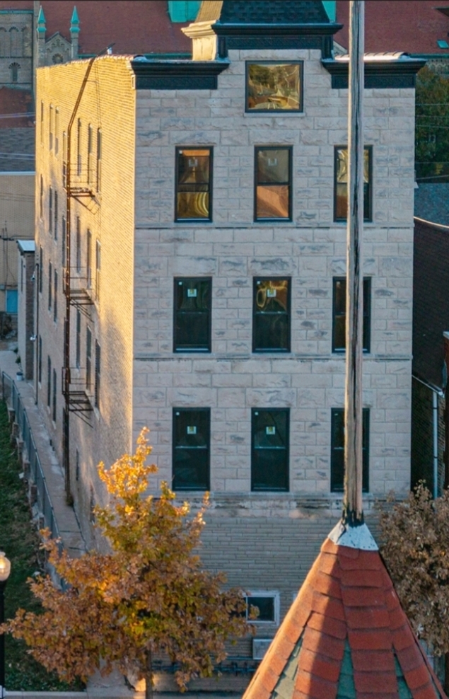a view of a brick house with a large windows