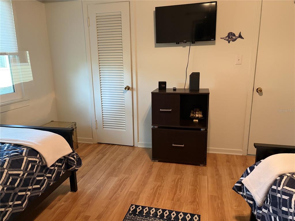 421 Riviera Street Venice, FL 34285 - Photo 14 of 30 a bedroom with a bed and a flat screen tv