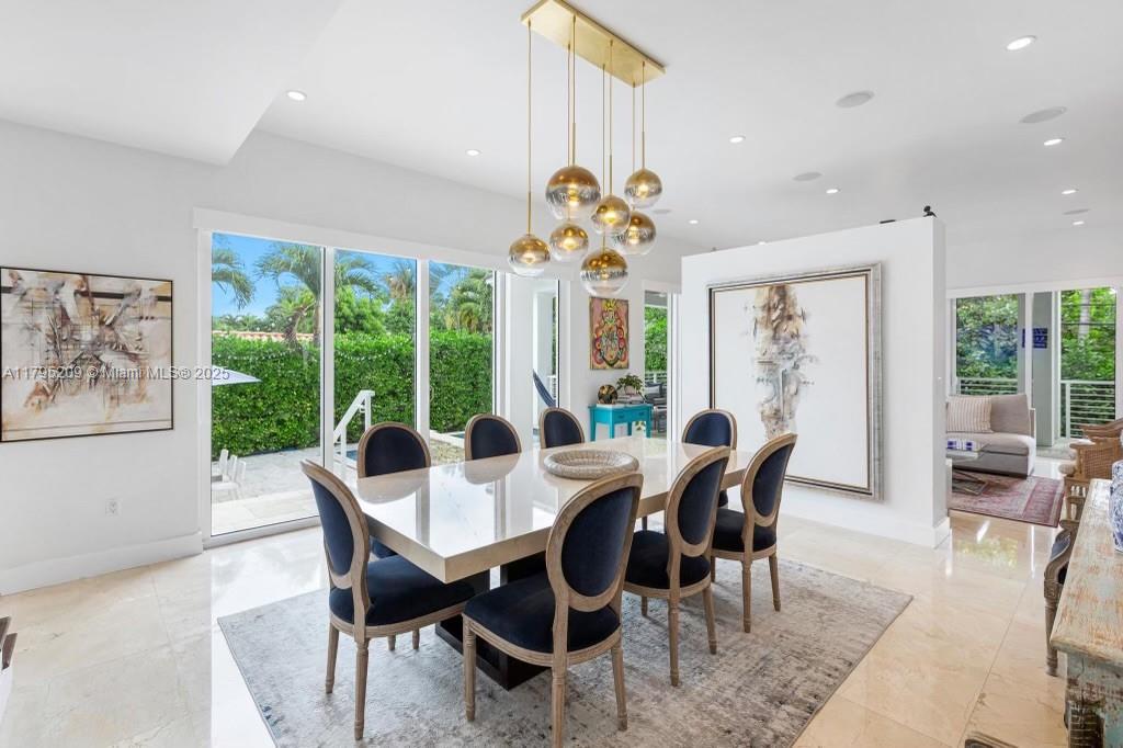 689 Glenridge Road Key Biscayne, FL 33149 - Photo 13 of 48 a view of a dining room with furniture large windows and wooden floor