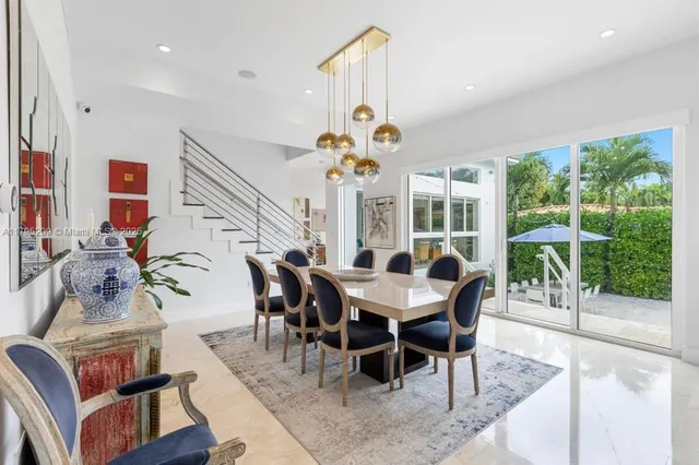 a dining room with furniture a chandelier and a rug