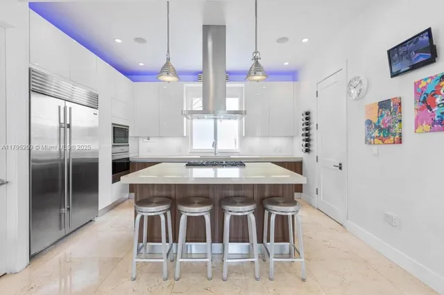 a kitchen with a table and refrigerator