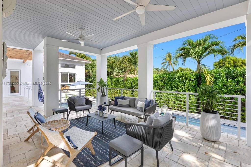 689 Glenridge Road Key Biscayne, FL 33149 - Photo 17 of 48 a living room with patio furniture and a potted plant
