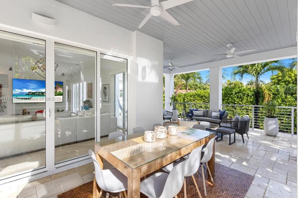 689 Glenridge Road Key Biscayne, FL 33149 - Photo 19 of 48 a dining room with furniture and a floor to ceiling window