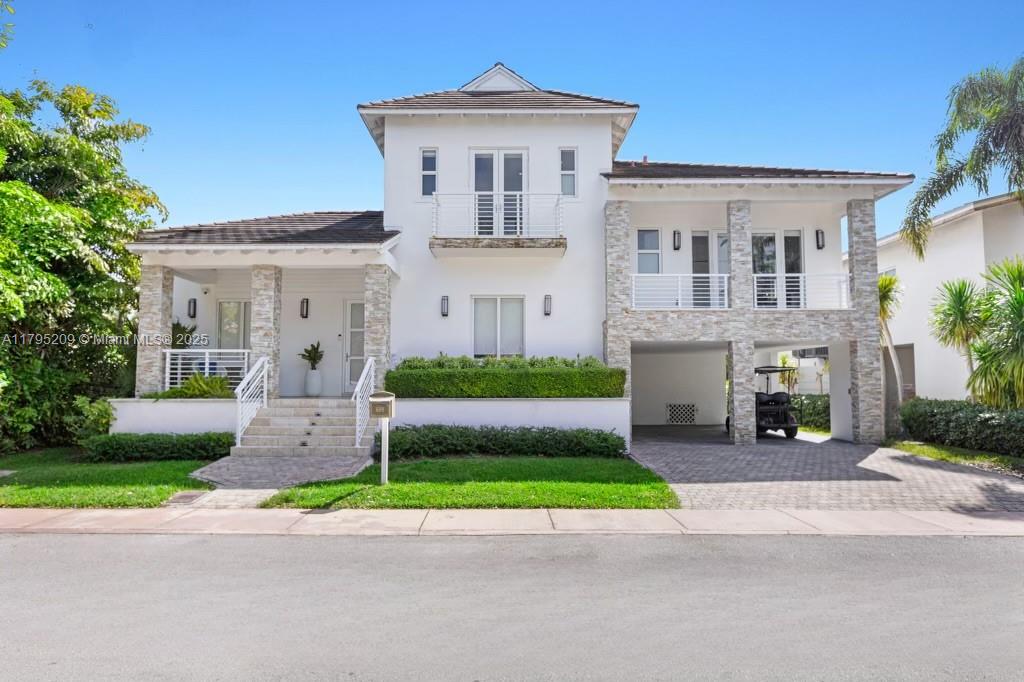 689 Glenridge Road Key Biscayne, FL 33149 - Photo 2 of 48 a front view of a house with a garden and yard