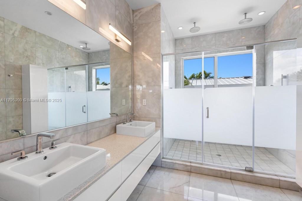 689 Glenridge Road Key Biscayne, FL 33149 - Photo 28 of 48 a spacious bathroom with a bathtub shower sink and mirror