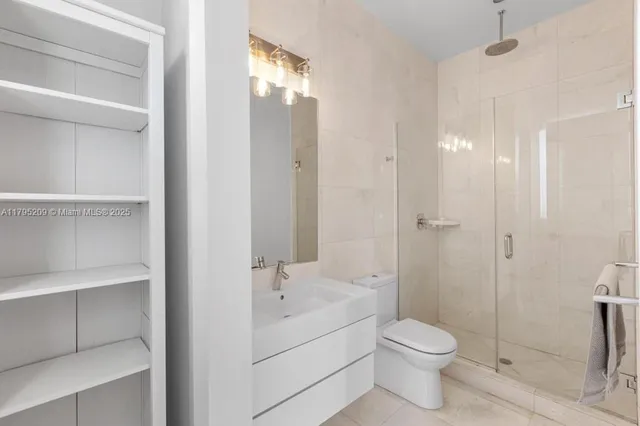 a bathroom with a toilet sink and shower