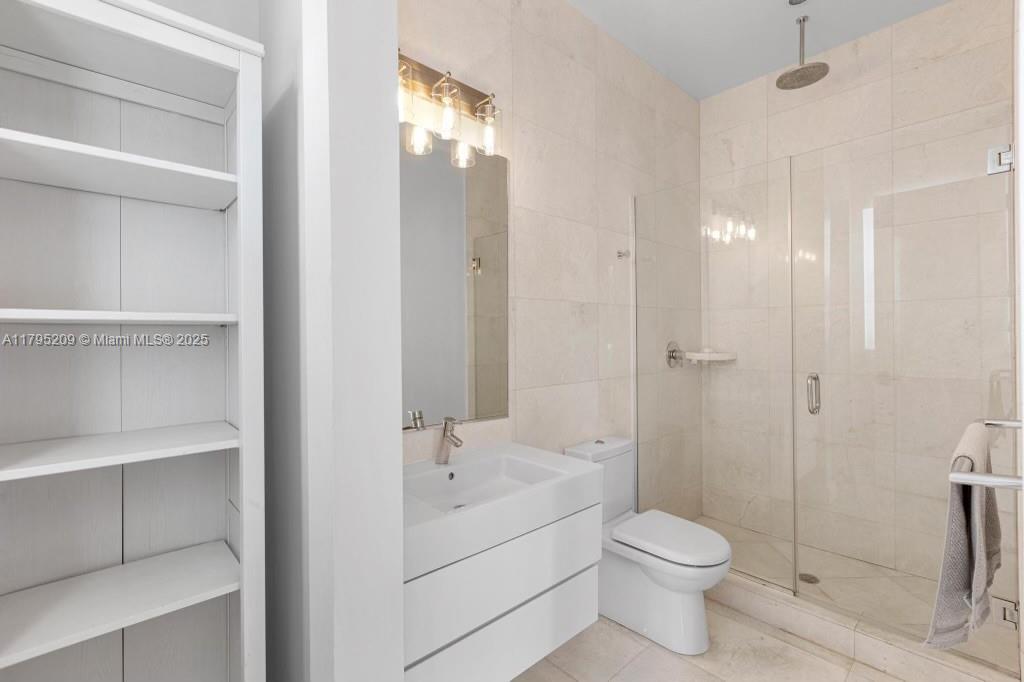 689 Glenridge Road Key Biscayne, FL 33149 - Photo 31 of 48 a bathroom with a toilet sink and shower