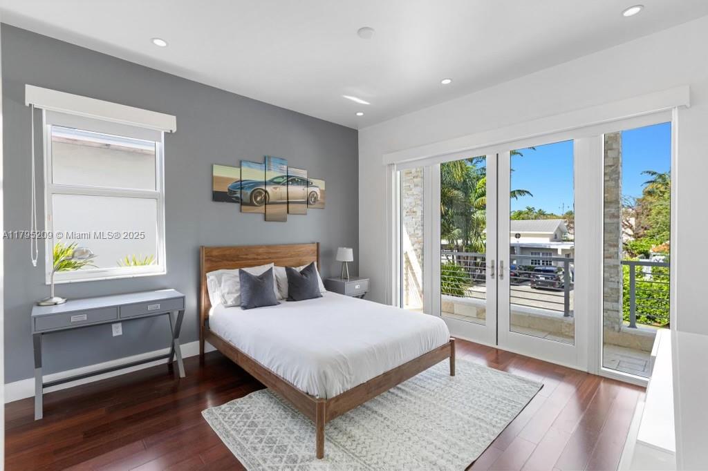 689 Glenridge Road Key Biscayne, FL 33149 - Photo 32 of 48 a bedroom with a large bed and a large window