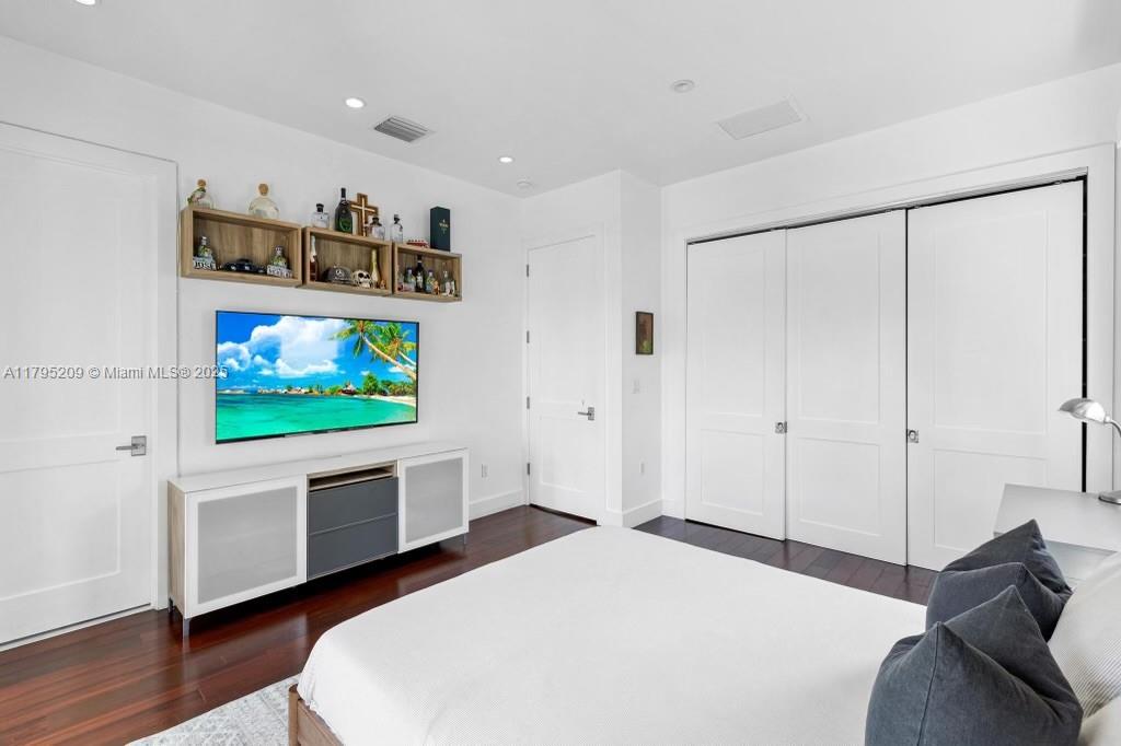 689 Glenridge Road Key Biscayne, FL 33149 - Photo 33 of 48 a bedroom with a bed and a flat screen tv