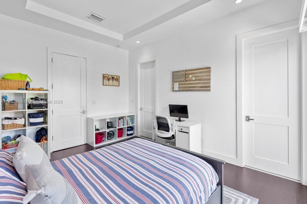 689 Glenridge Road Key Biscayne, FL 33149 - Photo 36 of 48 a bedroom with a bed and a flat tv screen on the dresser