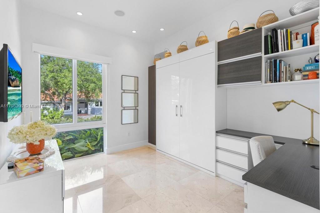 689 Glenridge Road Key Biscayne, FL 33149 - Photo 38 of 48 a hallway with a book shelf and a living room