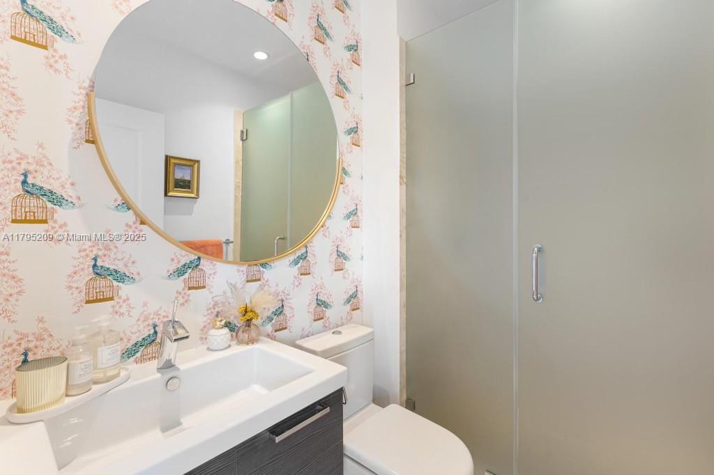 689 Glenridge Road Key Biscayne, FL 33149 - Photo 40 of 48 a bathroom with a sink mirror vanity and toilet