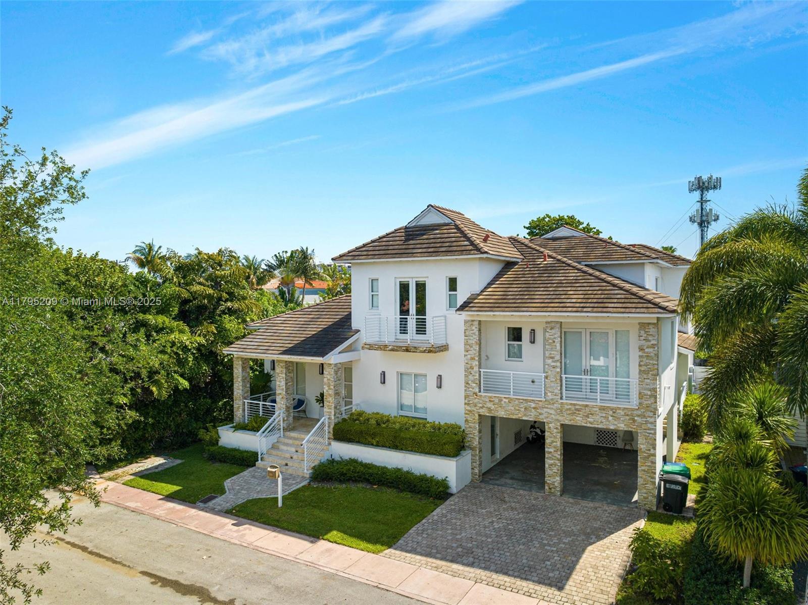 689 Glenridge Road Key Biscayne, FL 33149 - Photo 48 of 48 a front view of a house with a garden