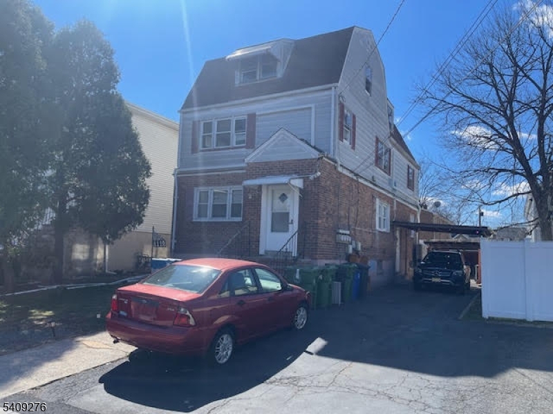 1112 Rivington Street Roselle, NJ 07203 - Photo 2 of 13 a front view of a house with a yard