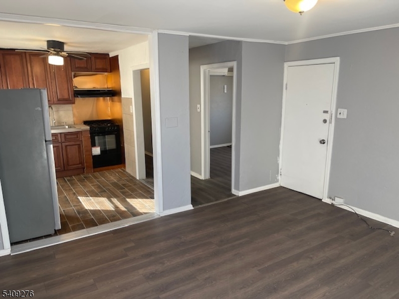 1112 Rivington Street Roselle, NJ 07203 - Photo 3 of 13 a view of empty room with wooden floor and window