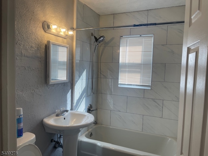 1112 Rivington Street Roselle, NJ 07203 - Photo 9 of 13 a bathroom with a sink toilet and shower