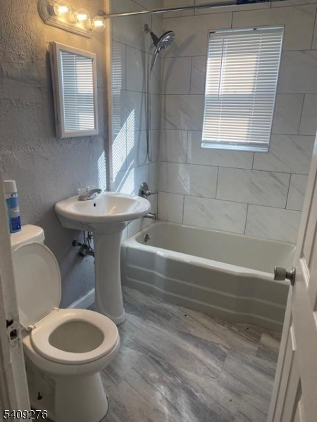 1112 Rivington Street Roselle, NJ 07203 - Photo 10 of 13 a bathroom with a sink toilet and shower