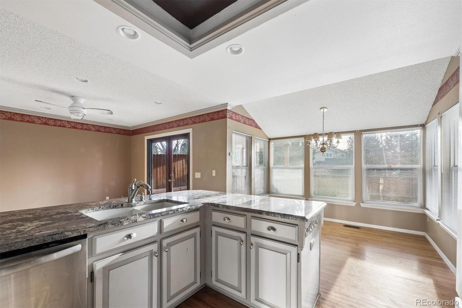 8554 Redstone Street Highlands Ranch, CO 80126 - Photo 11 of 33 a kitchen with a sink stove and cabinets