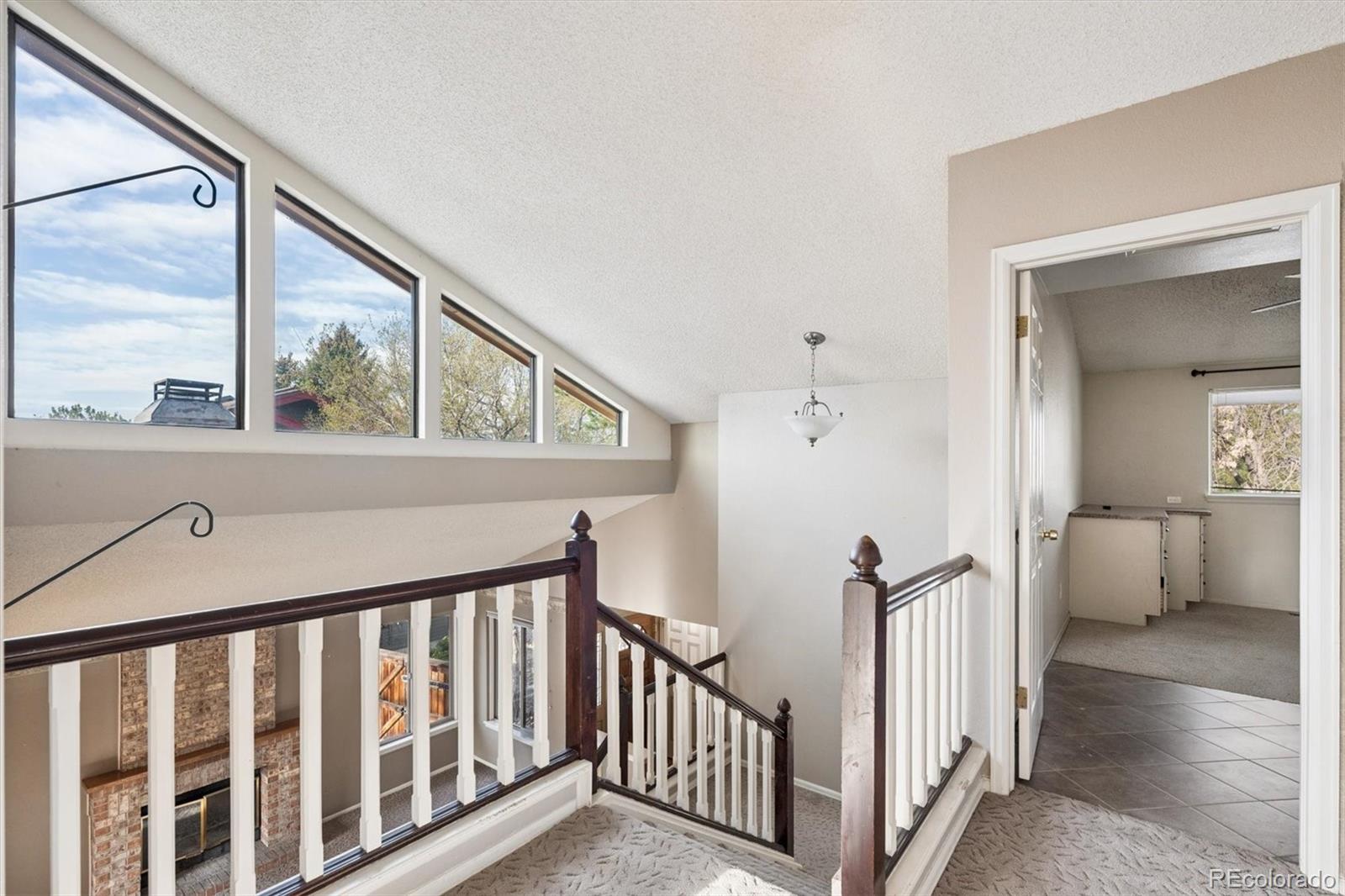 8554 Redstone Street Highlands Ranch, CO 80126 - Photo 19 of 33 a view of an entryway with wooden floor