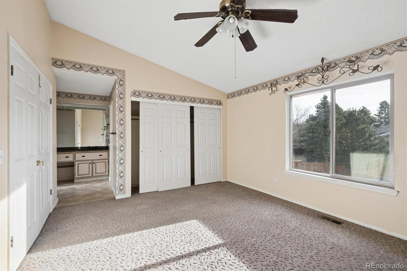 8554 Redstone Street Highlands Ranch, CO 80126 - Photo 20 of 33 a view of a big room with a chandelier fan and closet