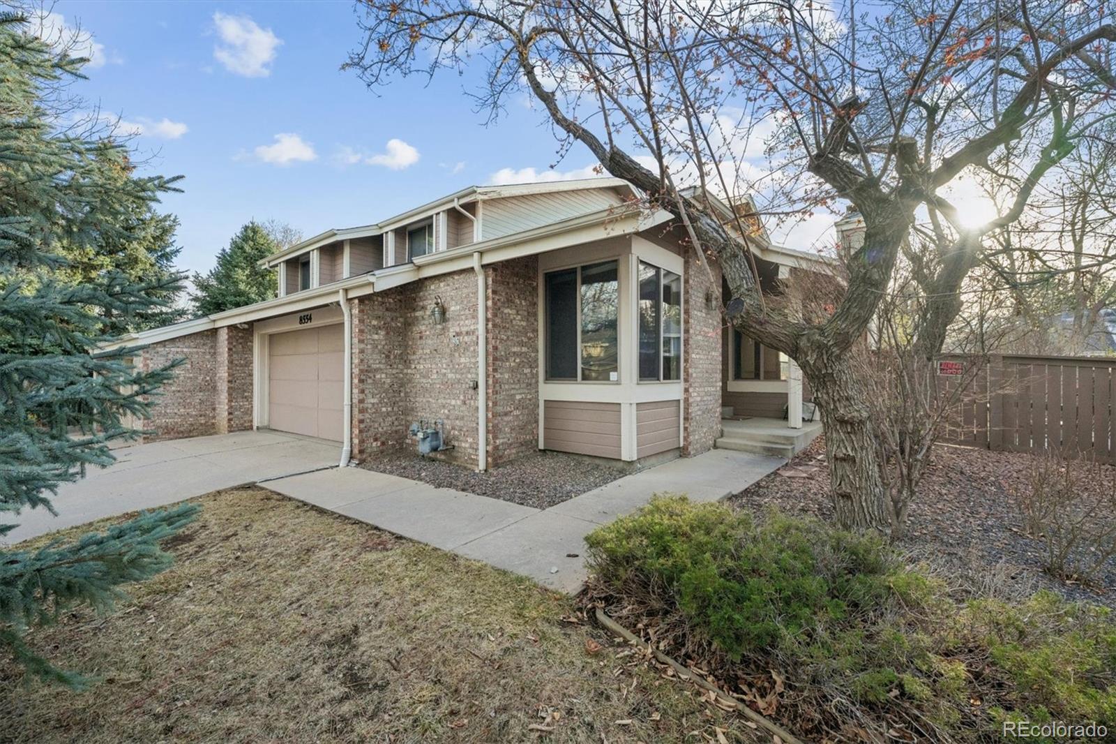 8554 Redstone Street Highlands Ranch, CO 80126 - Photo 2 of 33 a front view of a house with a yard and trees