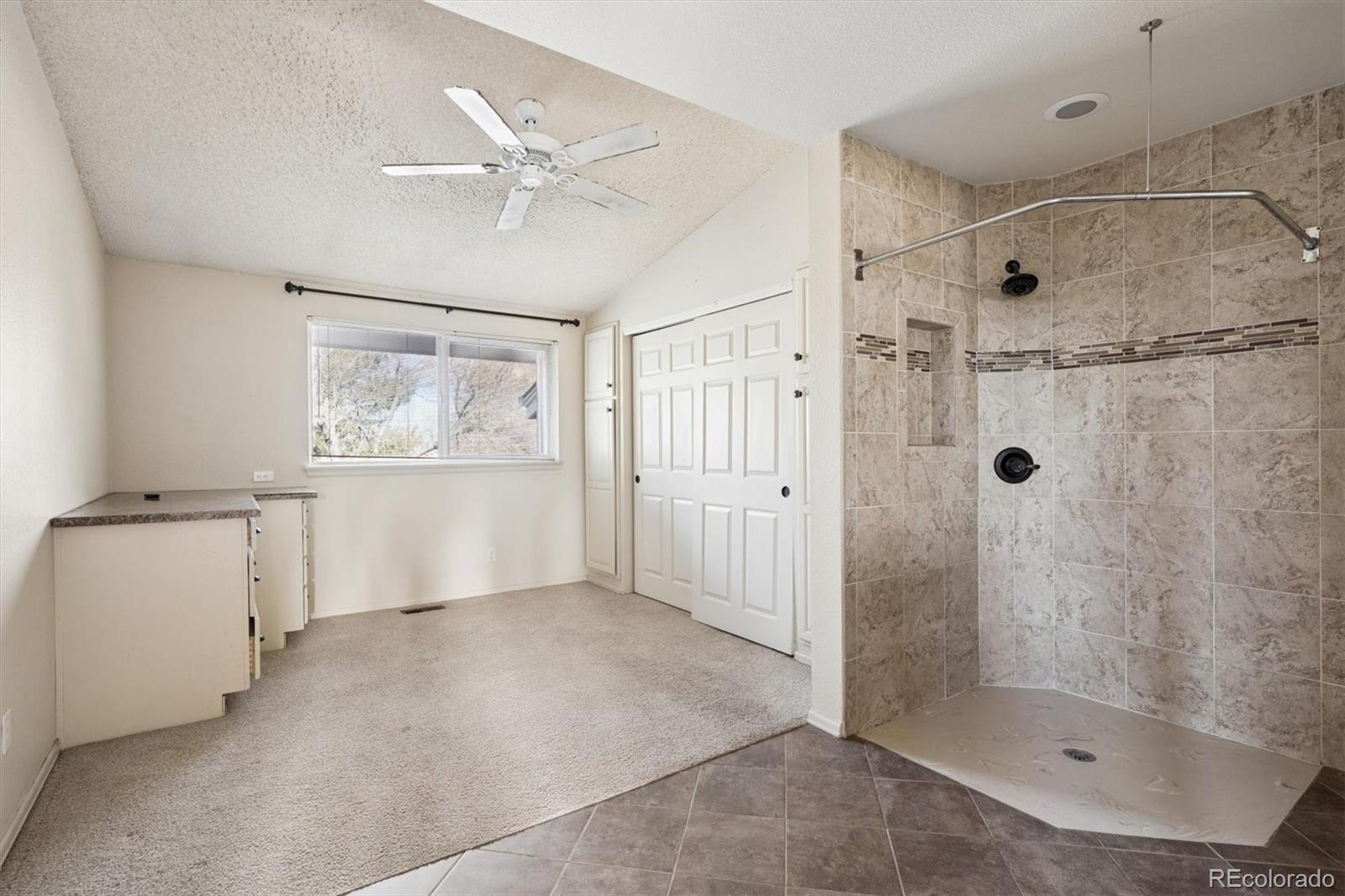 8554 Redstone Street Highlands Ranch, CO 80126 - Photo 23 of 33 a bathroom with a shower and a sink
