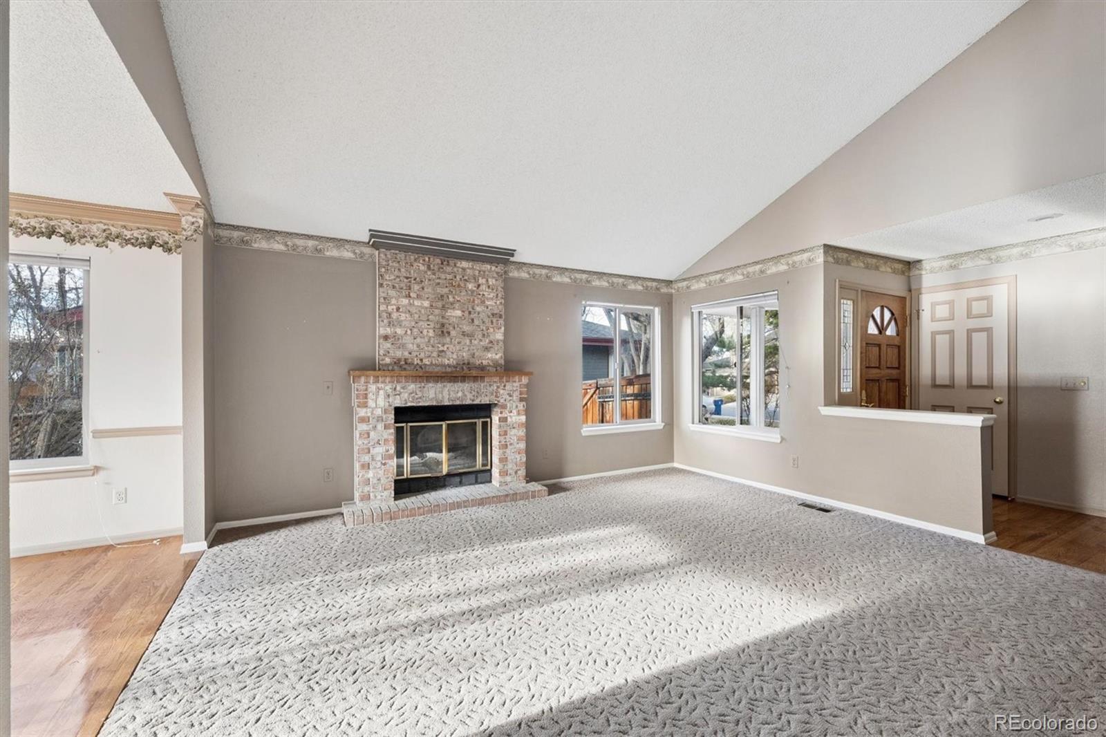 8554 Redstone Street Highlands Ranch, CO 80126 - Photo 5 of 33 a spacious bedroom with a large bed and a fireplace